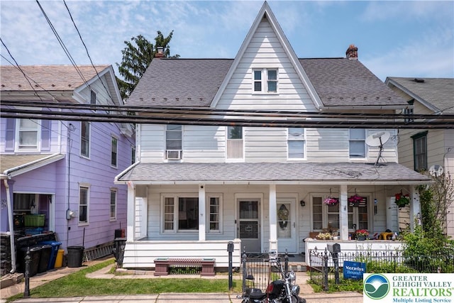 531 E Church St, Slatington Borough, PA 18080 - townhome / multi-family property featuring covered porch, a fenced front yard, a chimney, and a shingled roof