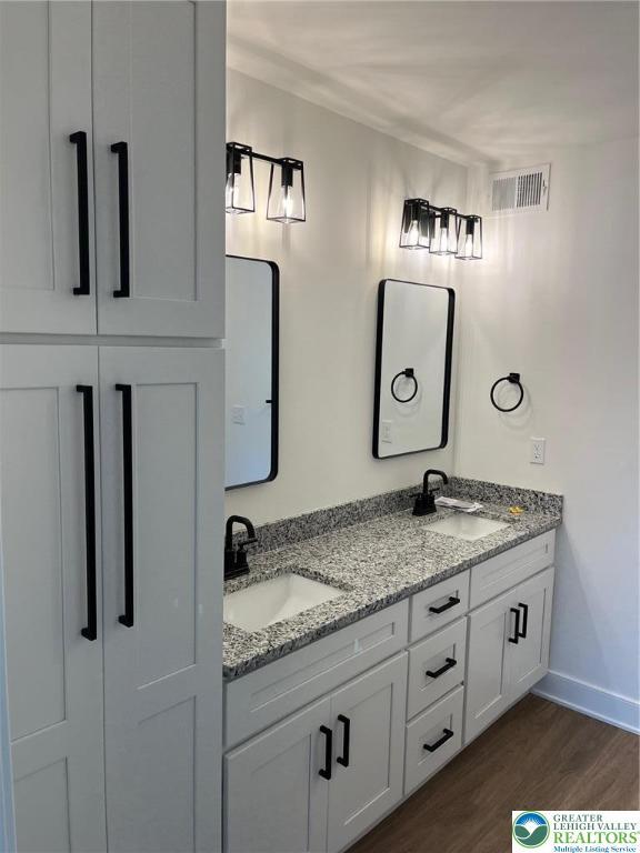 5268 Saddlebred Rd, South Whitehall Twp, PA 18104 - full bathroom featuring double vanity, wood finished floors, and baseboards