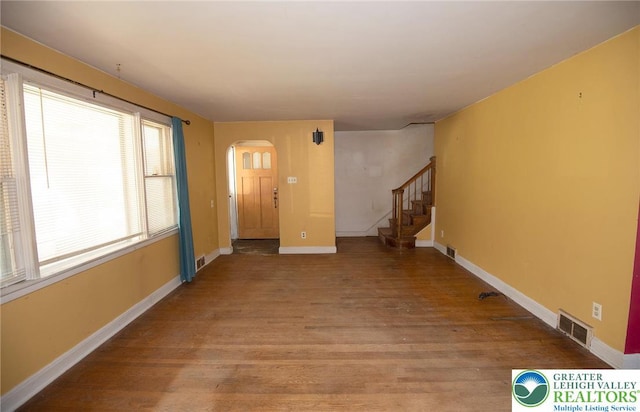665 Furnace St, Emmaus Borough, PA 18049 - spare room featuring arched walkways, wood finished floors, stairway, and baseboards