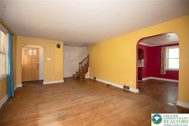 665 Furnace St, Emmaus Borough, PA 18049 - unfurnished living room with arched walkways, wood finished floors, stairway, and baseboards