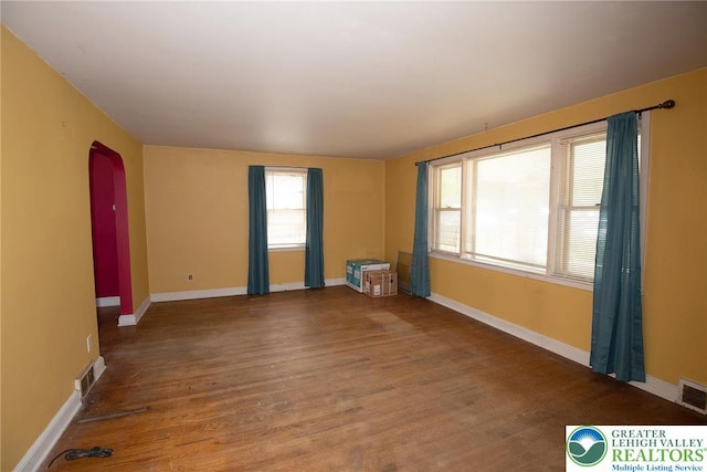 665 Furnace St, Emmaus Borough, PA 18049 - spare room with arched walkways, wood finished floors, and baseboards