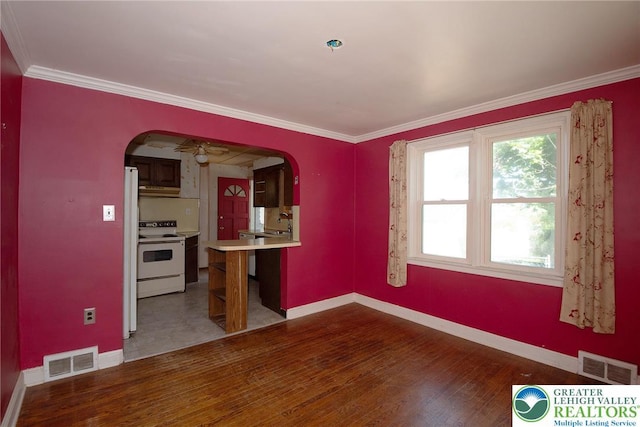 665 Furnace St, Emmaus Borough, PA 18049 - empty room featuring arched walkways, baseboards, wood finished floors, and ornamental molding