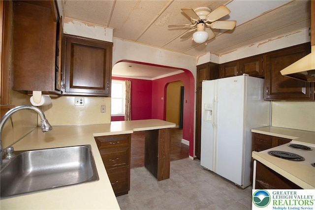 665 Furnace St, Emmaus Borough, PA 18049 - kitchen featuring a sink, light countertops, arched walkways, white refrigerator with ice dispenser, and ceiling fan
