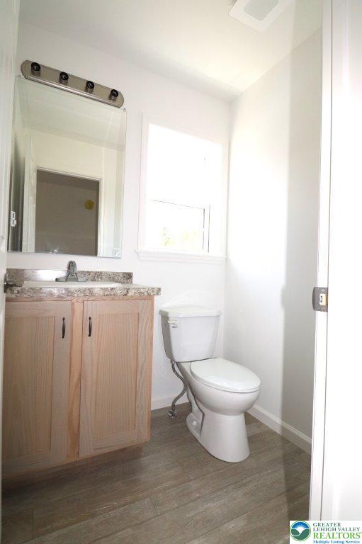 1025 W Princeton Ave, Palmerton Boro, PA 18071 - half bath featuring baseboards, toilet, vanity, and wood finished floors