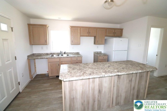 1025 W Princeton Ave, Palmerton Boro, PA 18071 - kitchen featuring freestanding refrigerator, a sink, wood finished floors, a center island, and light stone counters