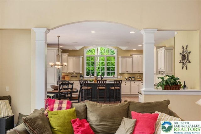 6335 Sweetbriar Ln, Upper Milford Twp, PA 18092 - living room featuring arched walkways, decorative columns, recessed lighting, and light wood-style flooring
