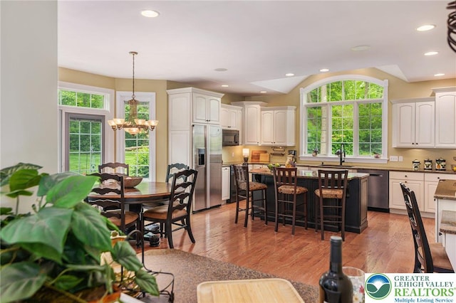 6335 Sweetbriar Ln, Upper Milford Twp, PA 18092 - dining space featuring a chandelier, healthy amount of natural light, light wood finished floors, recessed lighting, and lofted ceiling