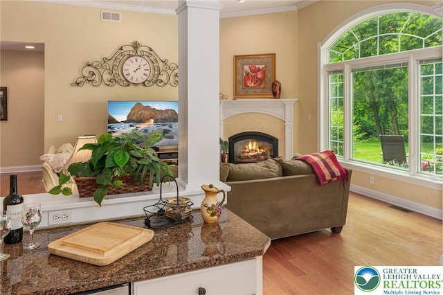 6335 Sweetbriar Ln, Upper Milford Twp, PA 18092 - living area featuring ornamental molding, light wood-type flooring, healthy amount of natural light, ornate columns, and a lit fireplace