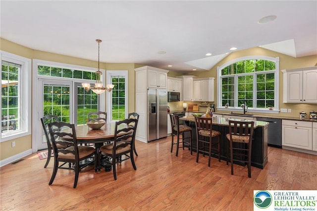 6335 Sweetbriar Ln, Upper Milford Twp, PA 18092 - dining space featuring a chandelier, light wood-type flooring, recessed lighting, and vaulted ceiling