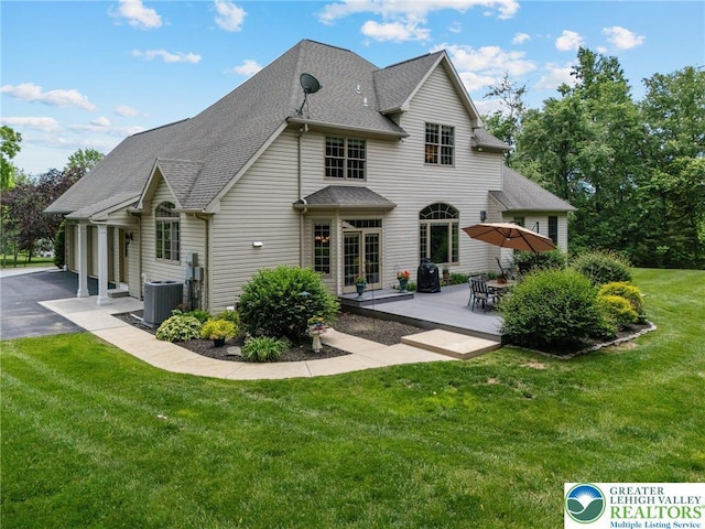 6335 Sweetbriar Ln, Upper Milford Twp, PA 18092 - back of property with a lawn, roof with shingles, asphalt driveway, and a patio area