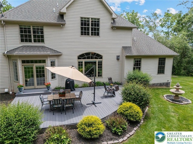 6335 Sweetbriar Ln, Upper Milford Twp, PA 18092 - back of property with a wooden deck, outdoor dining area, a yard, and a shingled roof