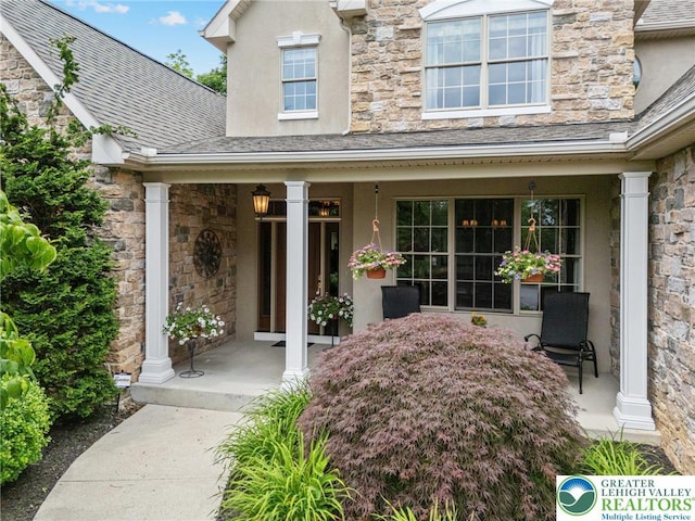 6335 Sweetbriar Ln, Upper Milford Twp, PA 18092 - entrance to property with covered porch, stone siding, and stucco siding