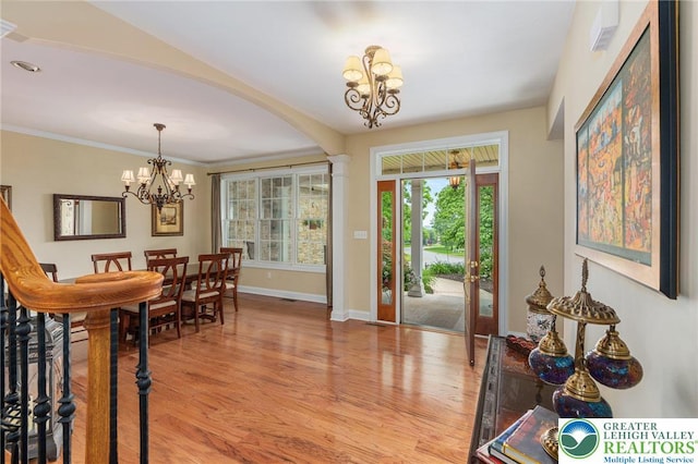 6335 Sweetbriar Ln, Upper Milford Twp, PA 18092 - foyer with a chandelier, light wood-style floors, and arched walkways