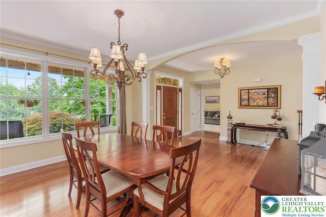 6335 Sweetbriar Ln, Upper Milford Twp, PA 18092 - dining room featuring a chandelier, arched walkways, light wood-style flooring, and crown molding