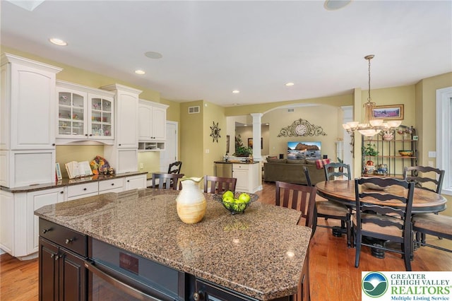 6335 Sweetbriar Ln, Upper Milford Twp, PA 18092 - kitchen featuring decorative columns, light wood finished floors, dark stone counters, and recessed lighting