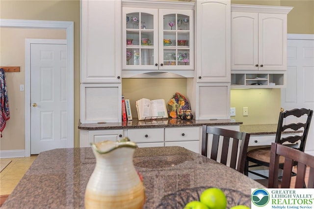 6335 Sweetbriar Ln, Upper Milford Twp, PA 18092 - kitchen featuring white cabinetry, glass insert cabinets, and dark stone countertops