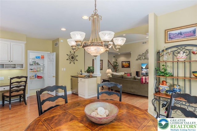 6335 Sweetbriar Ln, Upper Milford Twp, PA 18092 - dining area with light wood-style flooring, a chandelier, recessed lighting, and arched walkways
