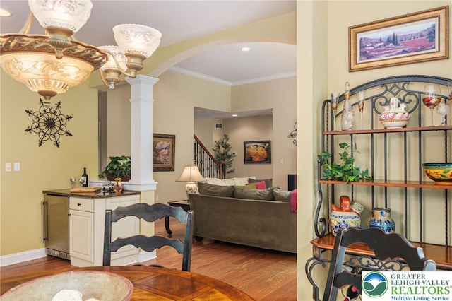 6335 Sweetbriar Ln, Upper Milford Twp, PA 18092 - dining area featuring decorative columns, arched walkways, wood finished floors, crown molding, and recessed lighting