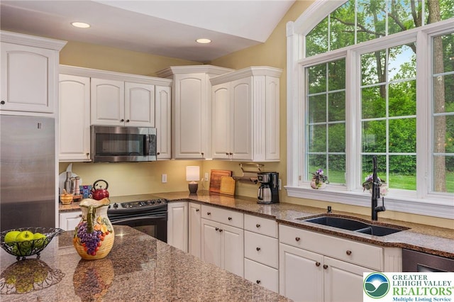 6335 Sweetbriar Ln, Upper Milford Twp, PA 18092 - kitchen with stainless steel appliances, white cabinetry, dark stone countertops, and recessed lighting