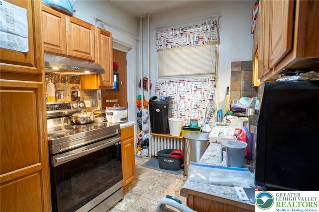 719 N 11th St, Allentown City, PA 18102 - kitchen with under cabinet range hood, stainless steel range with electric cooktop, light countertops, and brown cabinetry