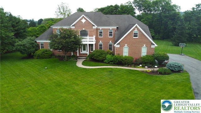 55 Forrest Stand Dr, Easton, PA 18042 - colonial inspired home featuring a front lawn, brick siding, and a balcony