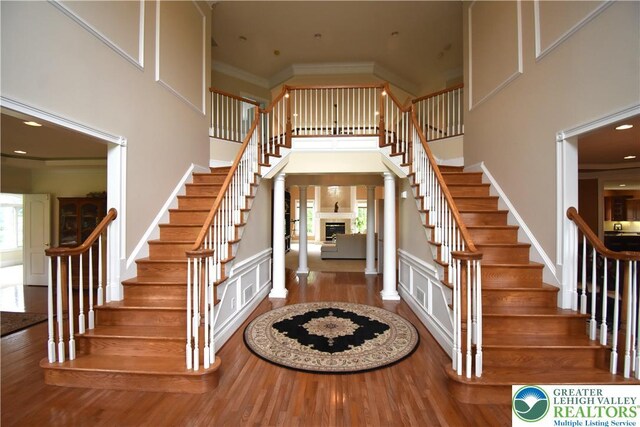 55 Forrest Stand Dr, Easton, PA 18042 - entrance foyer with stairway, wood finished floors, a high ceiling, a fireplace, and ornamental molding