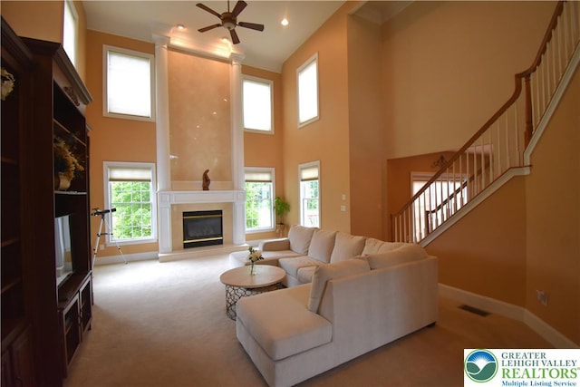55 Forrest Stand Dr, Easton, PA 18042 - living room featuring carpet, stairs, a high ceiling, ceiling fan, and baseboards