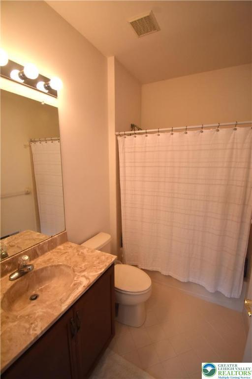 55 Forrest Stand Dr, Easton, PA 18042 - bathroom featuring vanity, toilet, tile patterned floors, and shower / bath combination with curtain