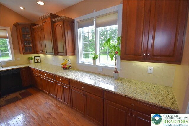 55 Forrest Stand Dr, Easton, PA 18042 - kitchen featuring dishwasher, decorative backsplash, light wood finished floors, light stone countertops, and glass insert cabinets