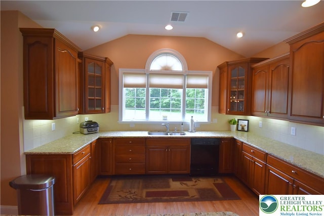 55 Forrest Stand Dr, Easton, PA 18042 - kitchen featuring dishwasher, a sink, wood finished floors, light stone countertops, and vaulted ceiling