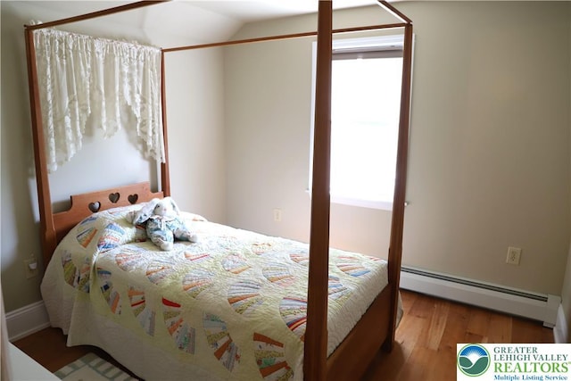 118 Burgoon Rd, Stroud Twp, PA 18301 - bedroom featuring a baseboard radiator, wood finished floors, multiple windows, and lofted ceiling
