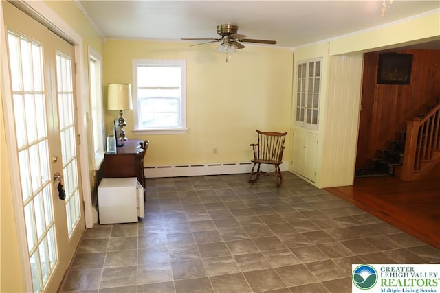 118 Burgoon Rd, Stroud Twp, PA 18301 - living area with a baseboard heating unit, crown molding, a ceiling fan, stairs, and french doors