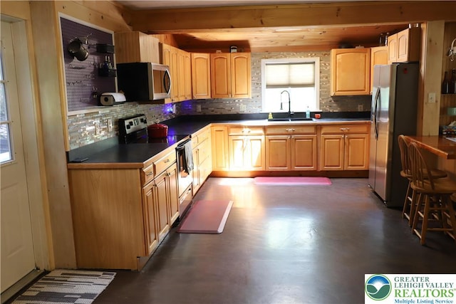 118 Burgoon Rd, Stroud Twp, PA 18301 - kitchen with appliances with stainless steel finishes, a sink, decorative backsplash, and finished concrete flooring