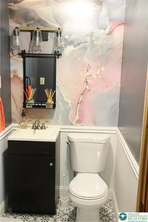 118 Burgoon Rd, Stroud Twp, PA 18301 - bathroom with vanity, toilet, tile patterned flooring, and wainscoting