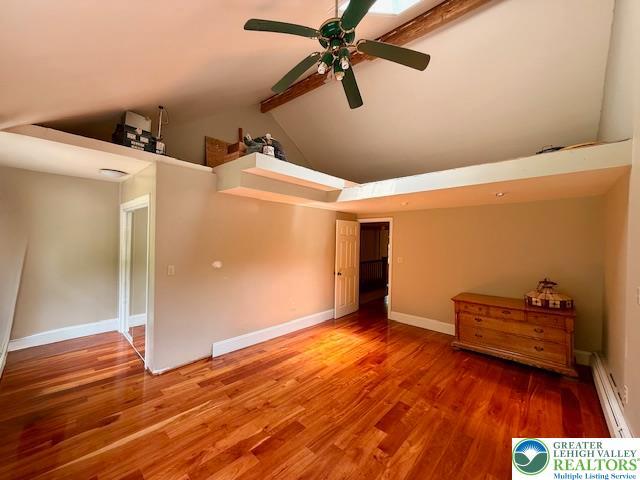 118 Burgoon Rd, Stroud Twp, PA 18301 - unfurnished bedroom with wood finished floors, high vaulted ceiling, baseboard heating, beam ceiling, and baseboards
