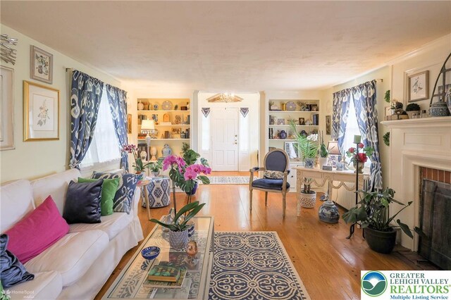 6650 Mountain Rd, Macungie Boro, PA 18062 - living area with built in features, hardwood / wood-style floors, and a fireplace with flush hearth