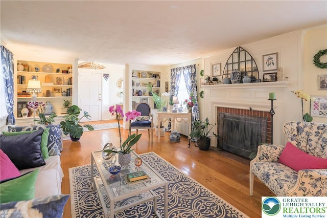 6650 Mountain Rd, Macungie Boro, PA 18062 - living room with built in shelves, wood finished floors, and a fireplace