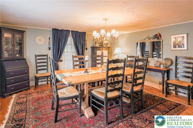6650 Mountain Rd, Macungie Boro, PA 18062 - dining space with ornamental molding, a chandelier, and wood finished floors