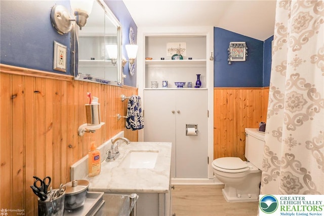 6650 Mountain Rd, Macungie Boro, PA 18062 - full bathroom with wood walls, wainscoting, vaulted ceiling, wood finished floors, and vanity