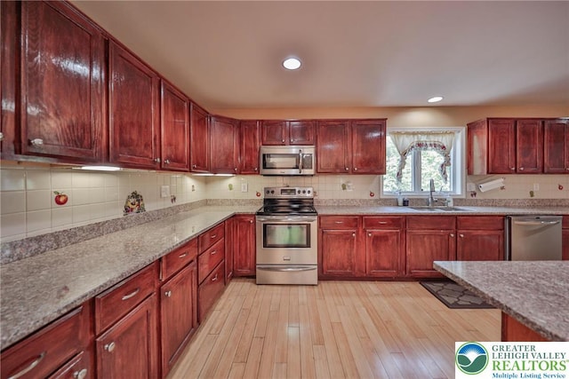 205 Osprey Way, Middle Smithfield Twp, PA 18302 - kitchen with appliances with stainless steel finishes, reddish brown cabinets, backsplash, and recessed lighting