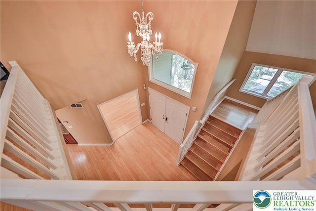 205 Osprey Way, Middle Smithfield Twp, PA 18302 - foyer entrance featuring stairs, a chandelier, a high ceiling, and wood finished floors