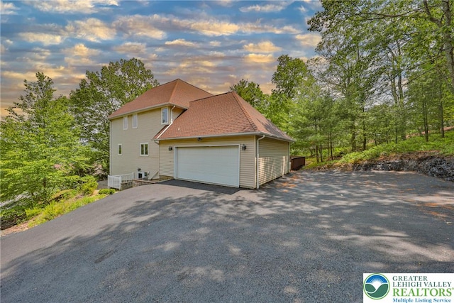 205 Osprey Way, Middle Smithfield Twp, PA 18302 - property exterior at dusk featuring asphalt driveway