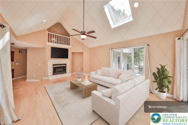 205 Osprey Way, Middle Smithfield Twp, PA 18302 - living area with light tile patterned floors, lofted ceiling, a fireplace, a skylight, and ceiling fan