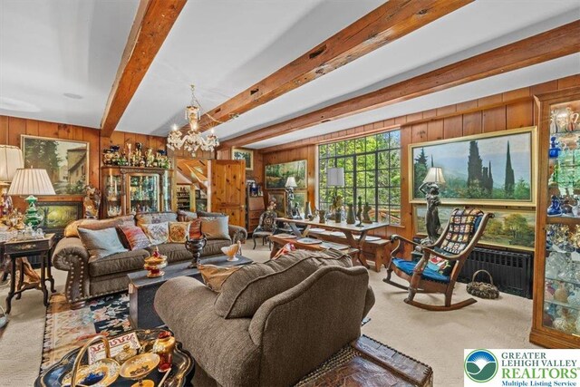 1341 Beaver Valley Rd, Hamilton Twp, PA 18360 - carpeted living area featuring wood walls, beam ceiling, a chandelier, and radiator heating unit