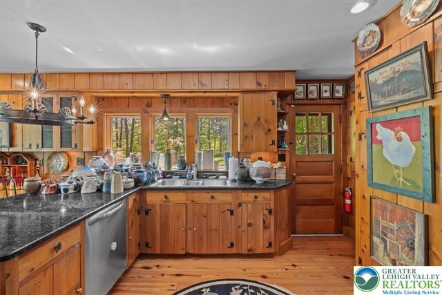 1341 Beaver Valley Rd, Hamilton Twp, PA 18360 - kitchen with stainless steel dishwasher, light wood-style floors, brown cabinets, healthy amount of natural light, and wood walls