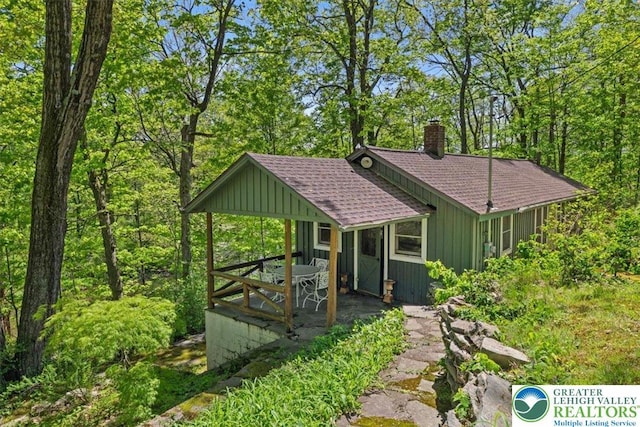 1341 Beaver Valley Rd, Hamilton Twp, PA 18360 - view of front of home with roof with shingles, board and batten siding, a chimney, and a hot tub