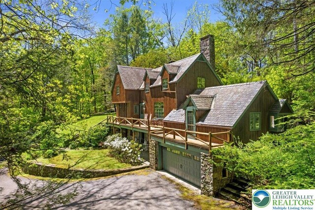 1341 Beaver Valley Rd, Hamilton Twp, PA 18360 - view of front facade featuring a chimney, asphalt driveway, and a deck