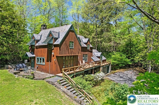 1341 Beaver Valley Rd, Hamilton Twp, PA 18360 - rear view of house with a chimney, french doors, a lawn, a deck, and a garage