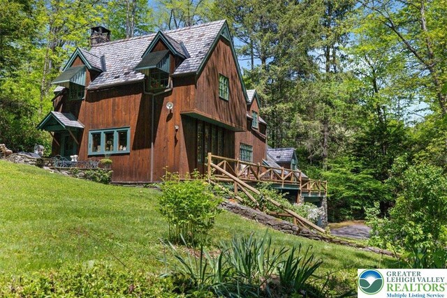 1341 Beaver Valley Rd, Hamilton Twp, PA 18360 - view of side of property featuring a chimney, a lawn, and a deck