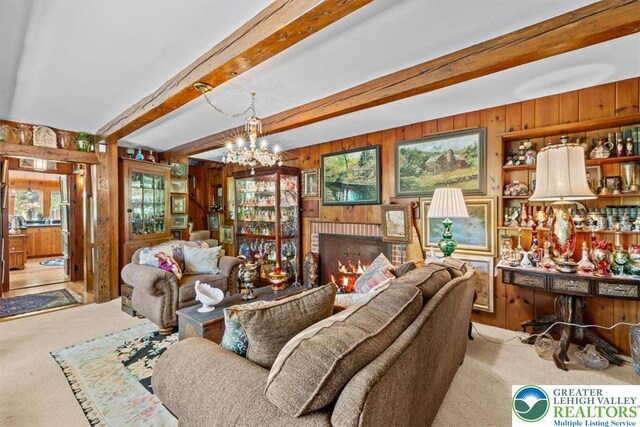 1341 Beaver Valley Rd, Hamilton Twp, PA 18360 - carpeted living area featuring wood walls, beamed ceiling, a chandelier, and a fireplace